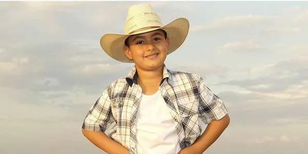 Young boy wearing a cowboy hat.